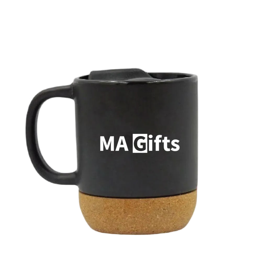 A black ceramic mug with a cork base and a white 'MA Gifts' logo printed on the front, shown against a plain white background.